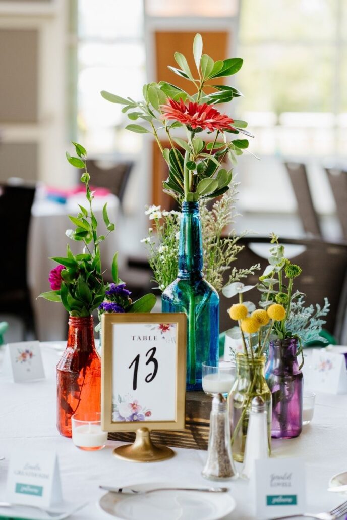 colorful vases and flowers at wedding reception
