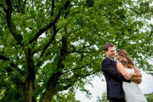 wedding couple outside with trees
