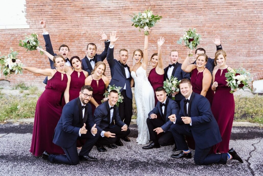 bridal party cranberry dresses and navy suits