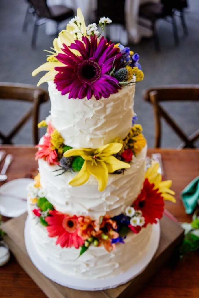 three tier wedding cake with colorful flowers