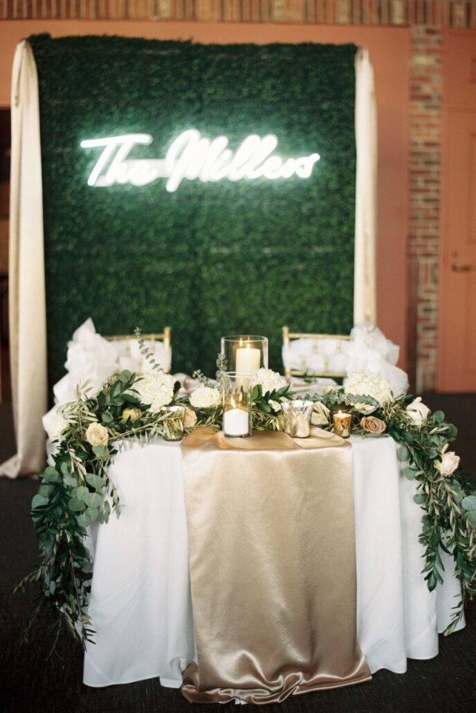grass wall backdrop in front of sweetheart table